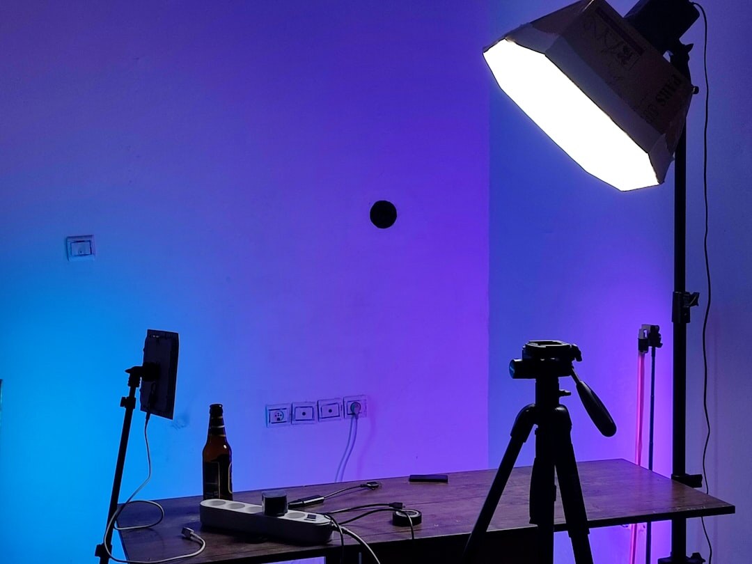 Professional broadcast camera on a tripod in bright studio light